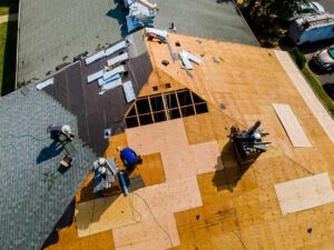 A homeowner using binoculars to examine the condition of a residential roof from the yard.